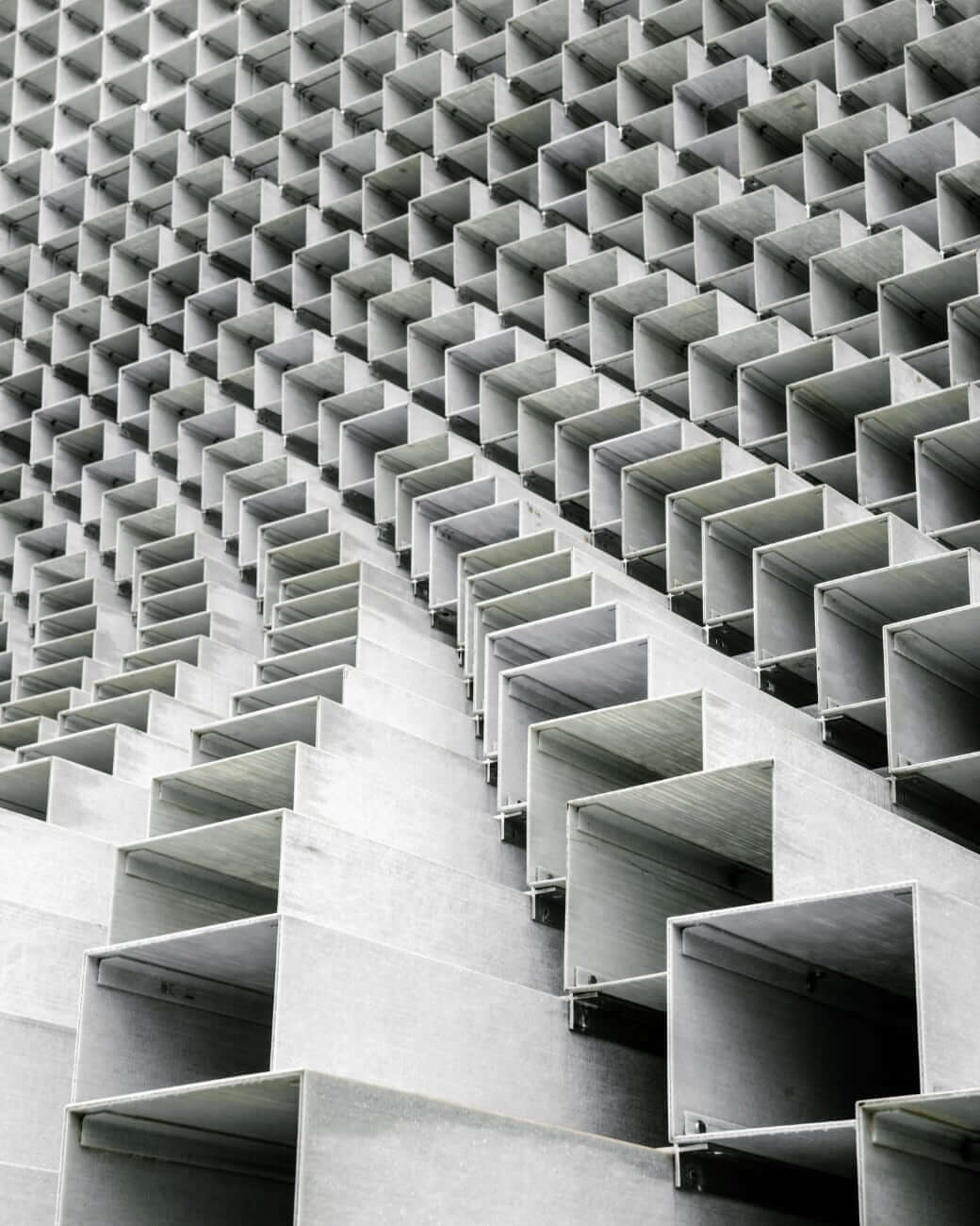 Abstract structure of boxes stacked in a wall bending toward you