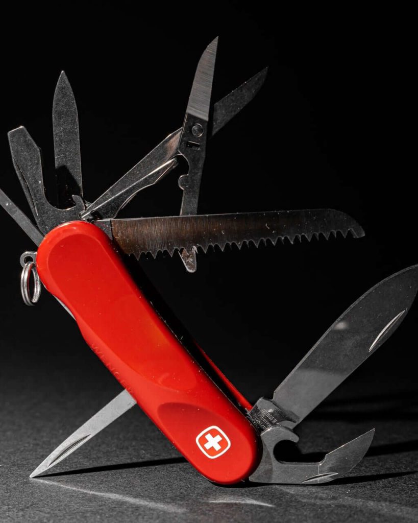 Photo of Swiss Army knife propped on-end with all of its tools fanned open