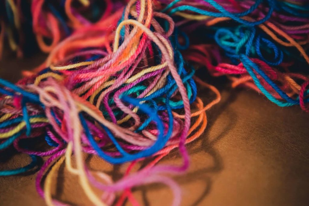 Photo of a jumble of rainbow-colored yarn