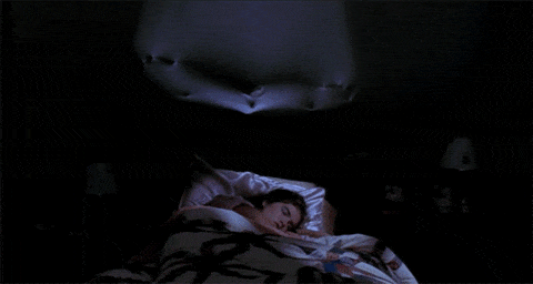 Animated GIF of Freddy Krueger pushing through stretchy wall above a sleeping woman